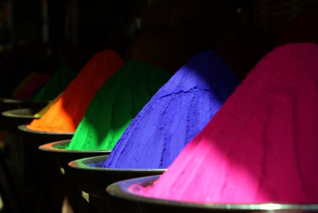 A vibrant display of colorful Holi powders, symbolizing celebration and joy.